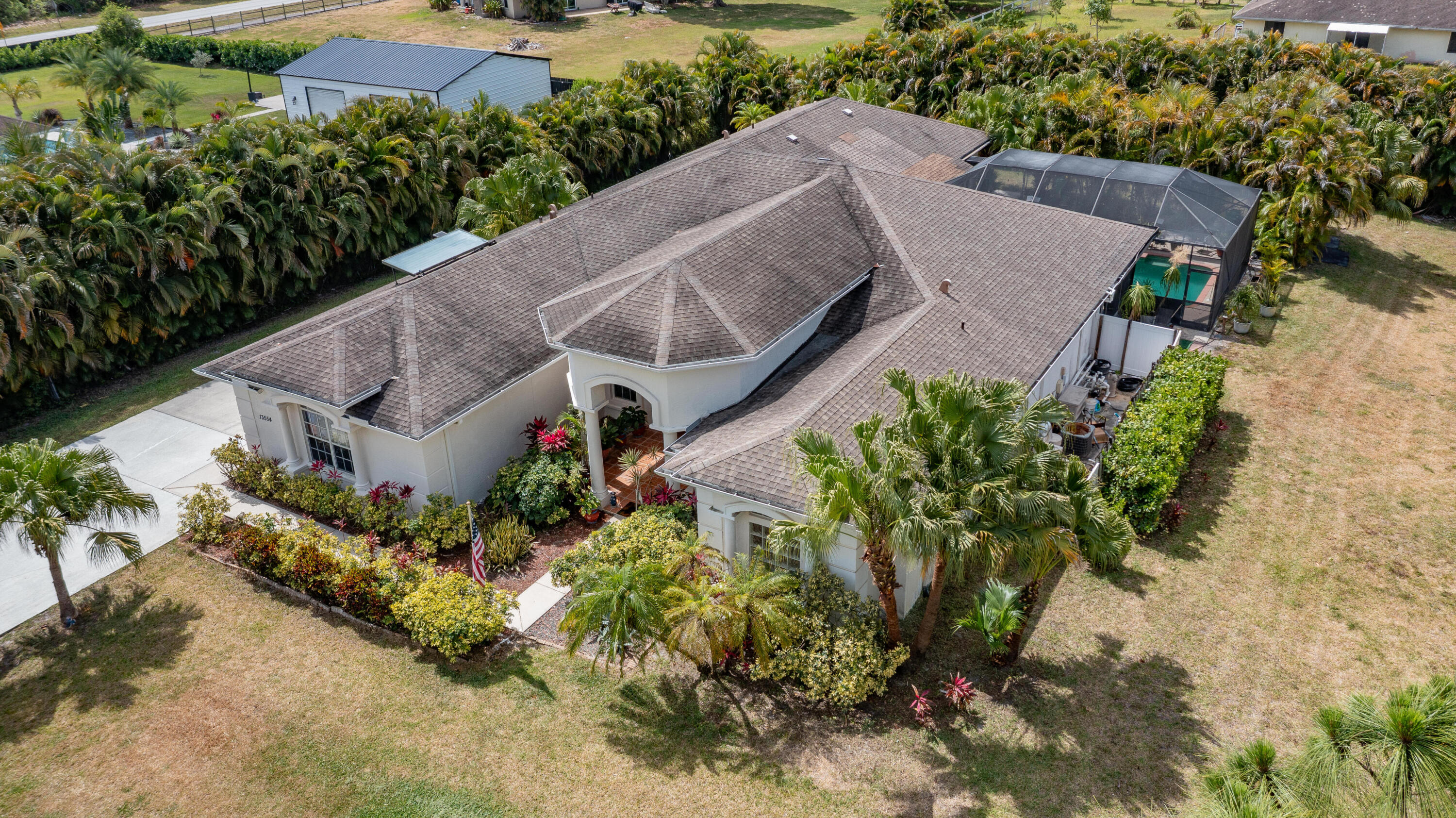 13554 86th Road North West Palm Beach, FL 33412 - Photo 3 of 58 an aerial view of a house with a yard and a large tree