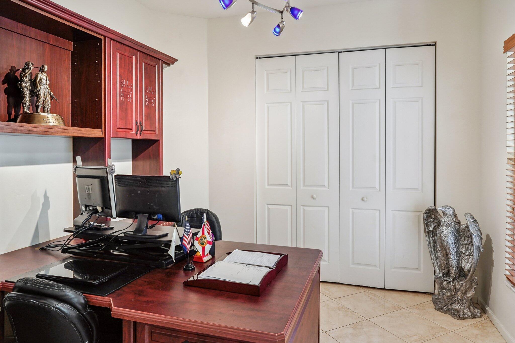 13554 86th Road North West Palm Beach, FL 33412 - Photo 37 of 58 a view of a workspace with furniture and a window