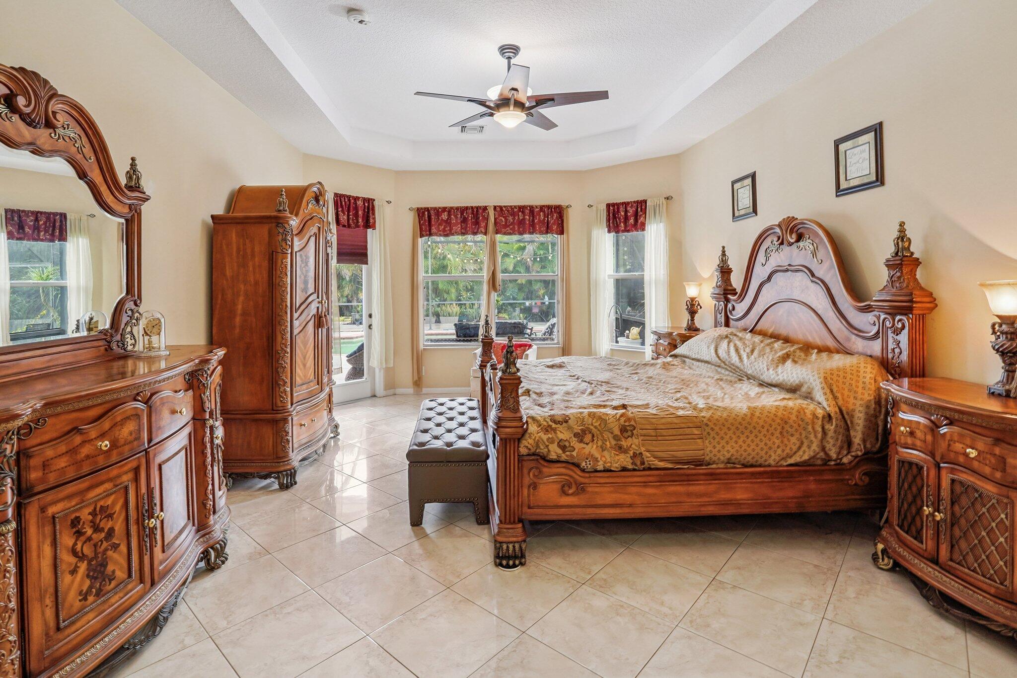 13554 86th Road North West Palm Beach, FL 33412 - Photo 38 of 58 a bedroom with a bed and a chandelier
