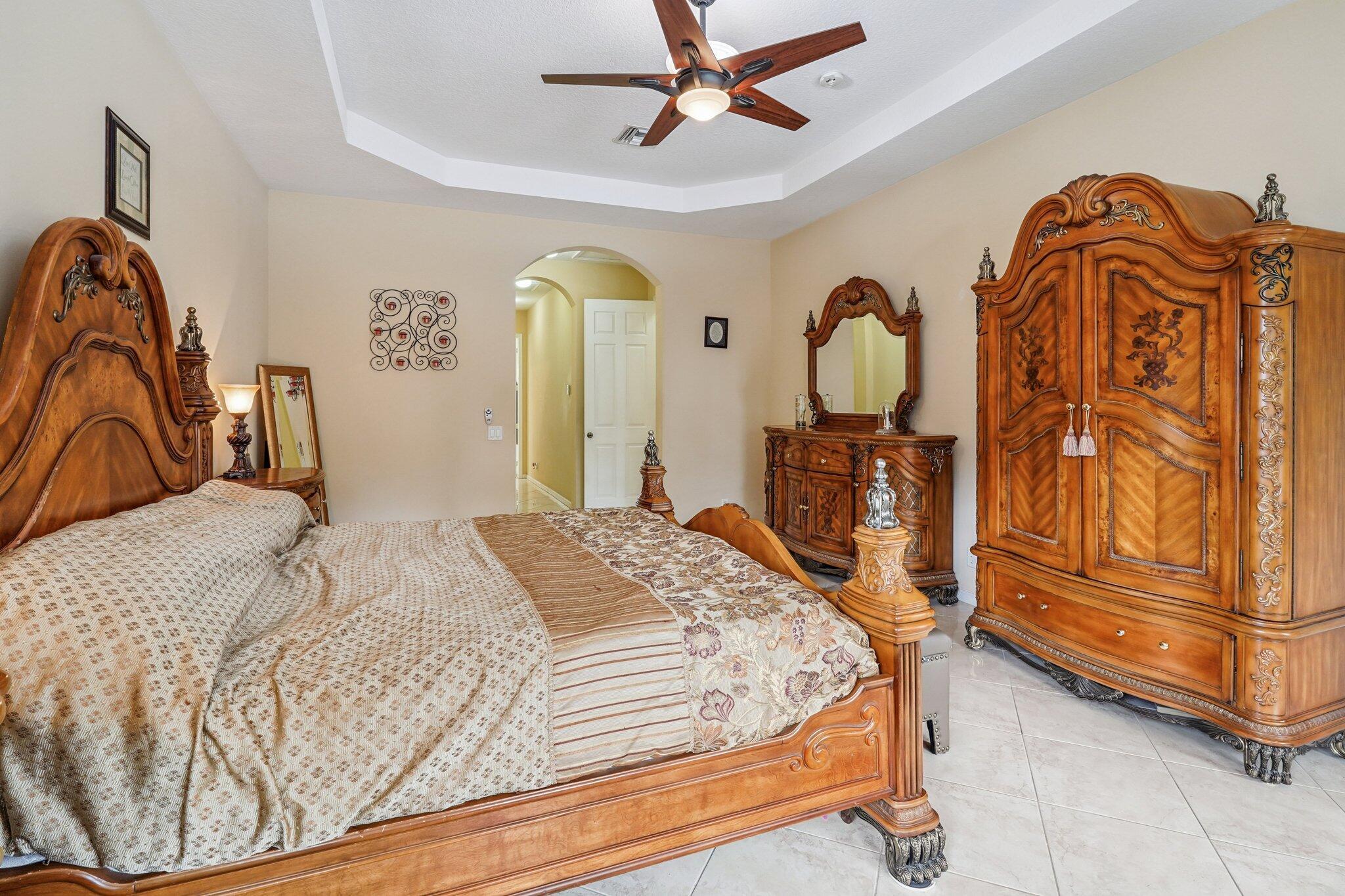 13554 86th Road North West Palm Beach, FL 33412 - Photo 39 of 58 a bedroom with a bed dresser and a window