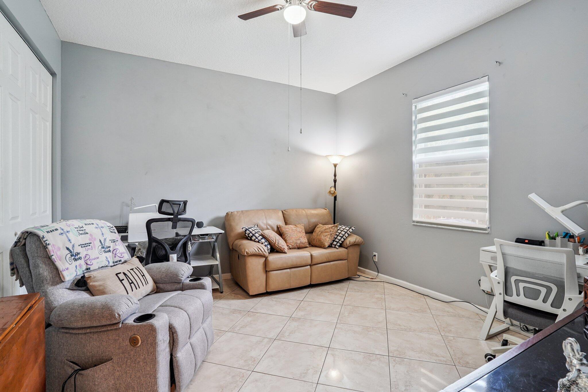 13554 86th Road North West Palm Beach, FL 33412 - Photo 44 of 58 a living room with furniture and a flat screen tv