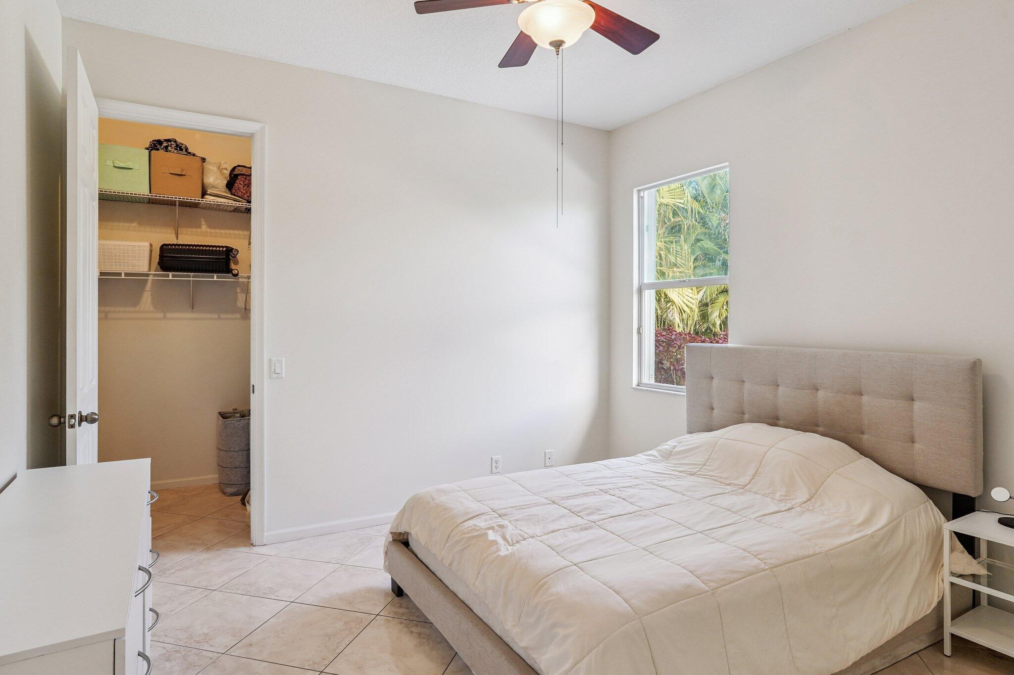 13554 86th Road North West Palm Beach, FL 33412 - Photo 47 of 58 a bedroom with a bed and a chandelier