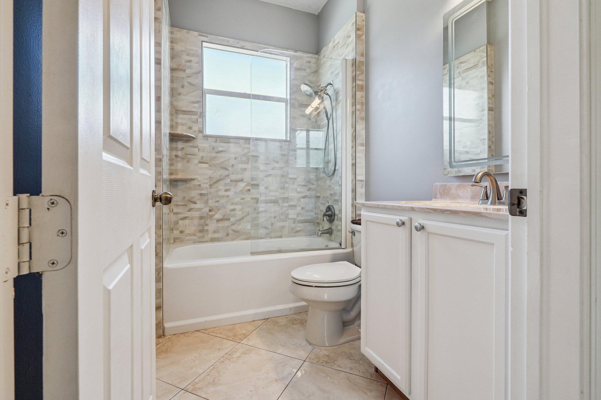 13554 86th Road North West Palm Beach, FL 33412 - Photo 49 of 58 a bathroom with a toilet sink and bathtub