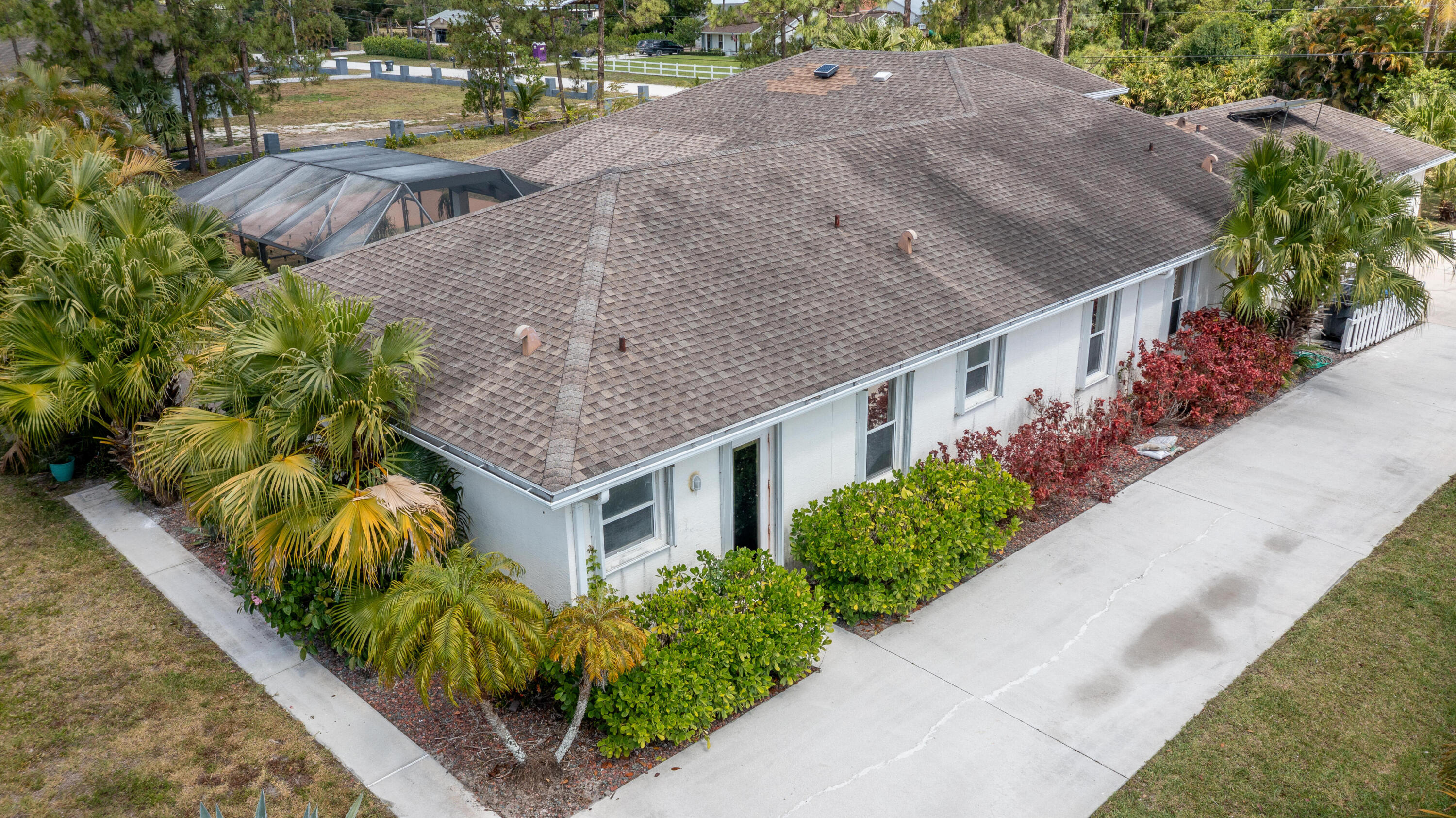 13554 86th Road North West Palm Beach, FL 33412 - Photo 5 of 58 a aerial view of a house with a yard and plants