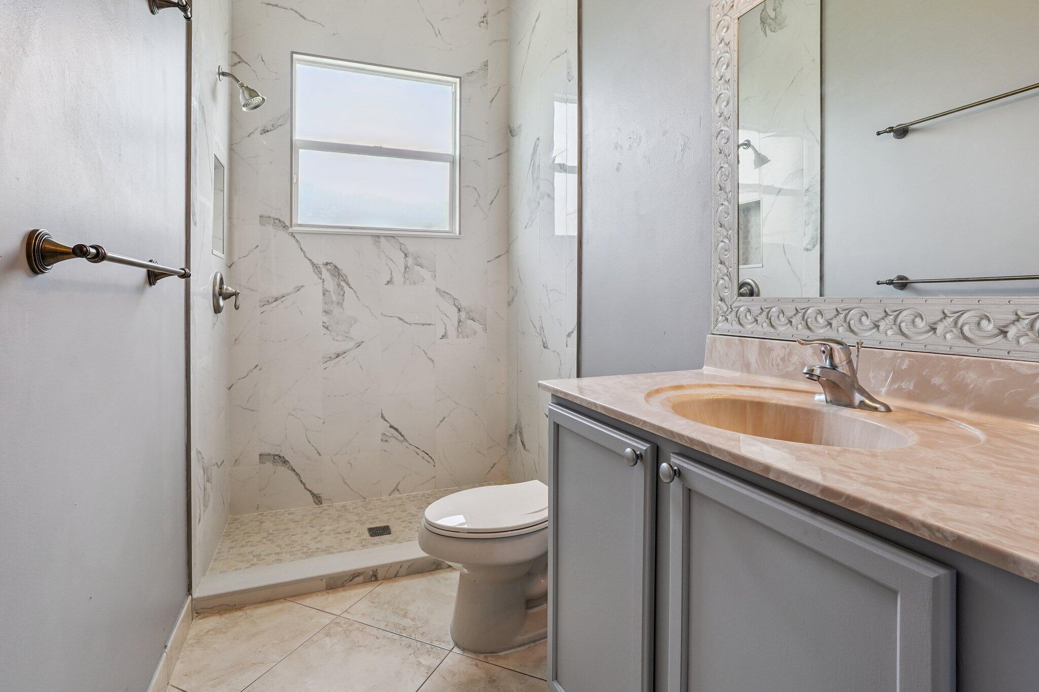 13554 86th Road North West Palm Beach, FL 33412 - Photo 53 of 58 a bathroom with a granite countertop sink a toilet and shower