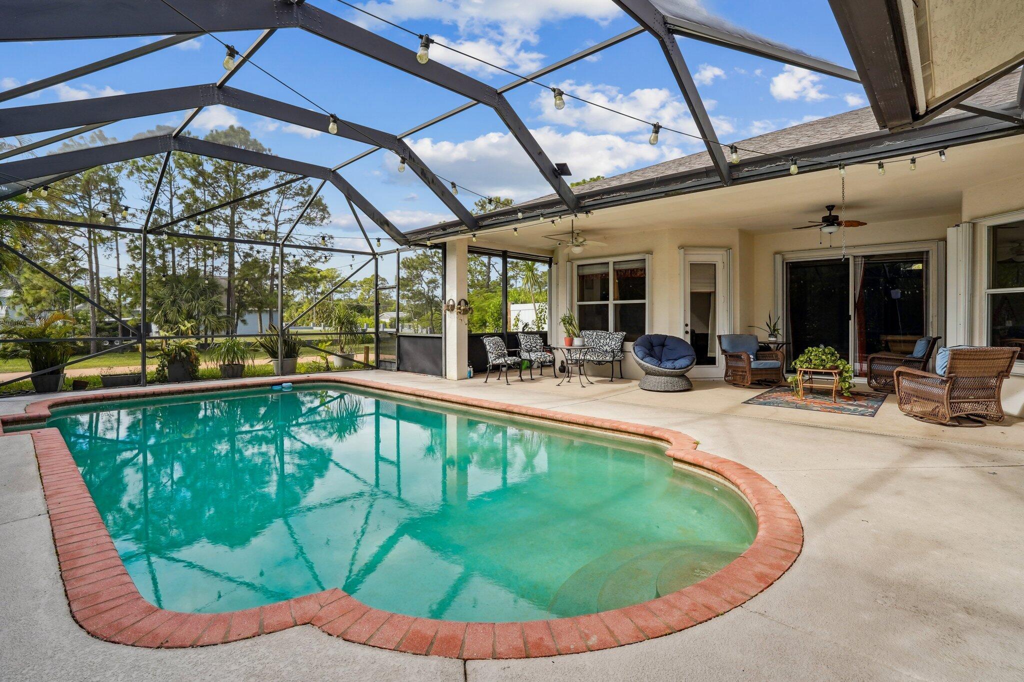 13554 86th Road North West Palm Beach, FL 33412 - Photo 55 of 58 a view of a swimming pool with a patio