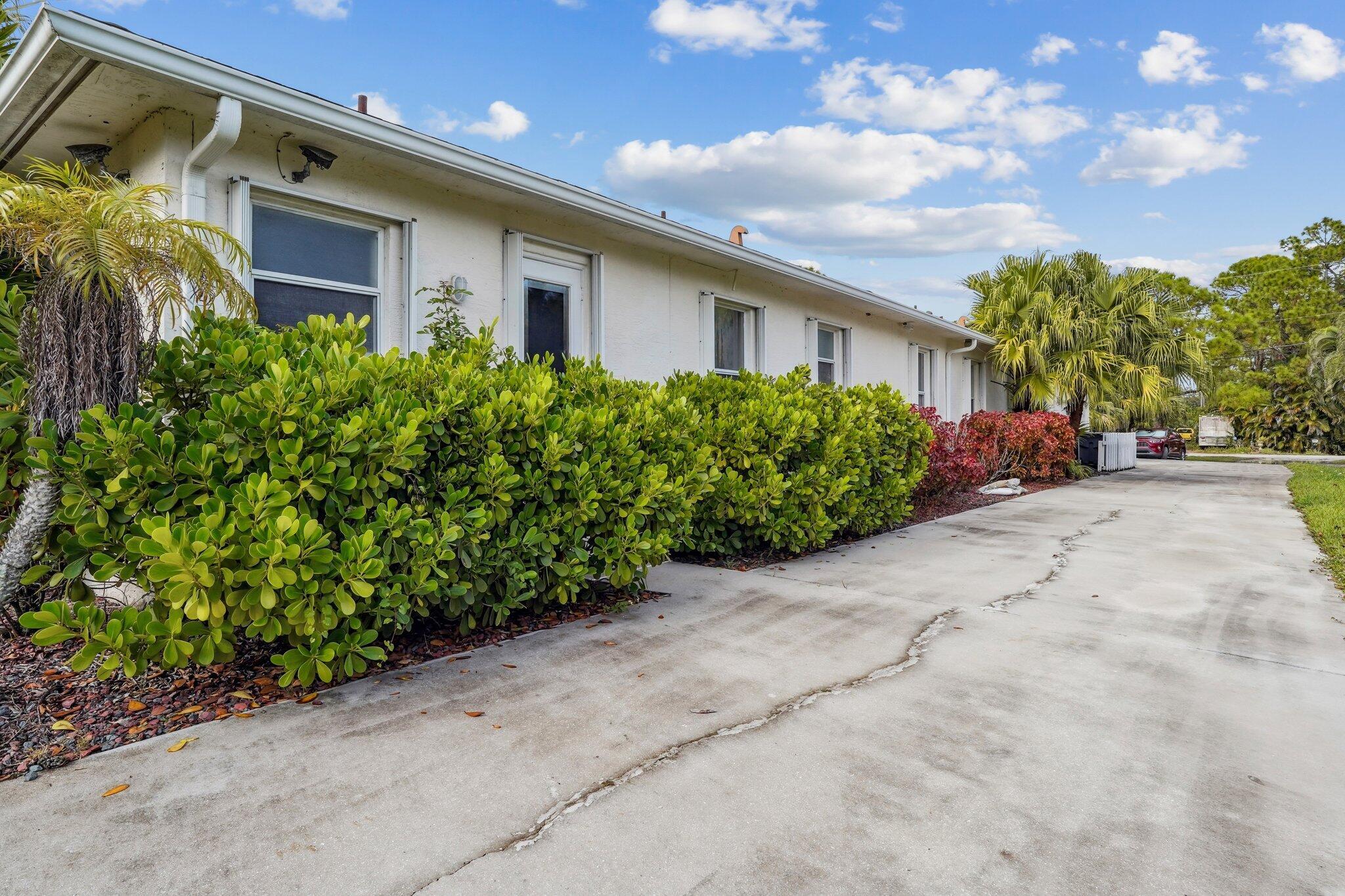 13554 86th Road North West Palm Beach, FL 33412 - Photo 57 of 58 a front view of a house with garden
