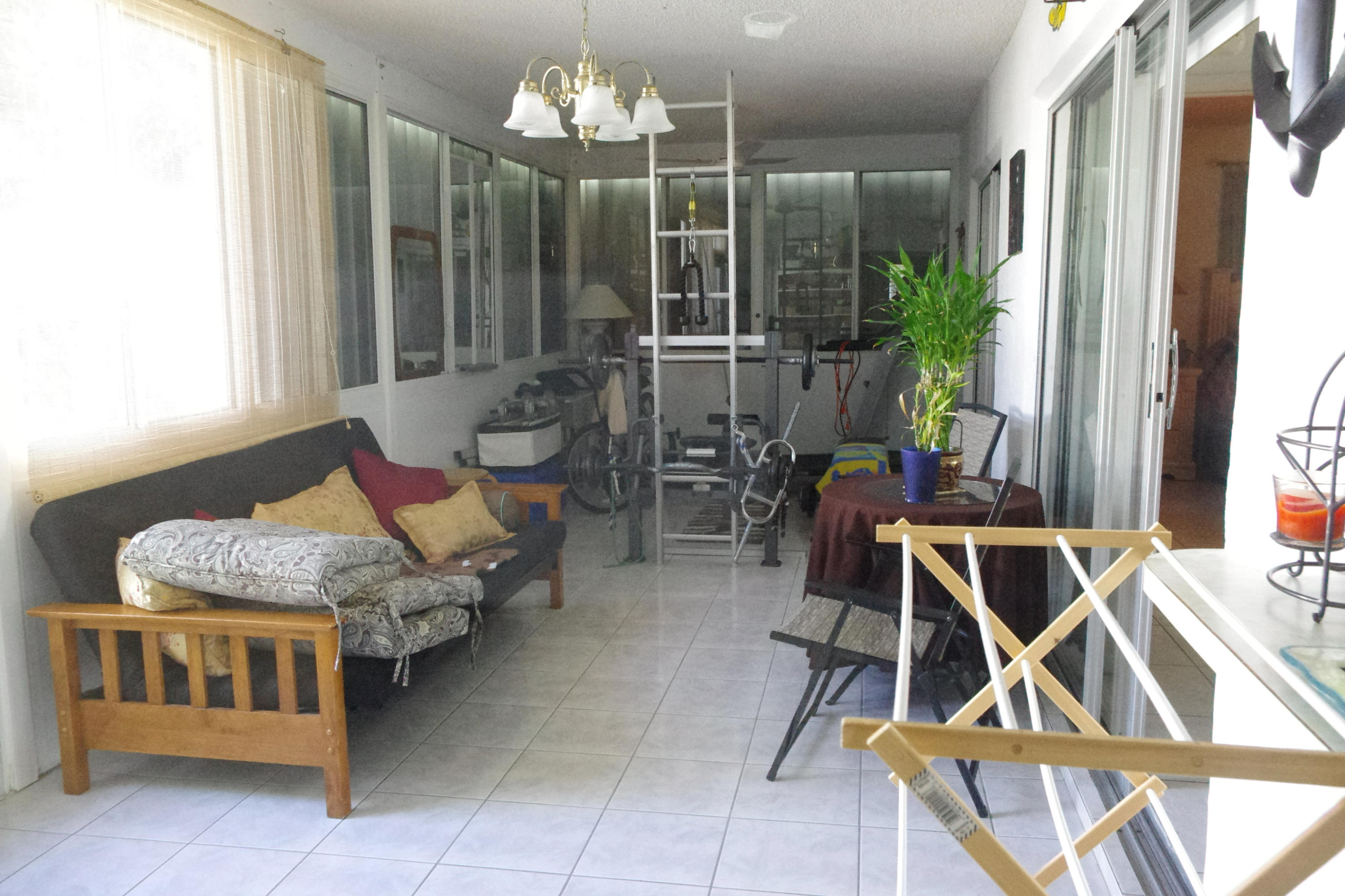 1310 Southwest 22nd Street Boynton Beach, FL 33426 - Photo 14 of 16 a living room with furniture and a chandelier