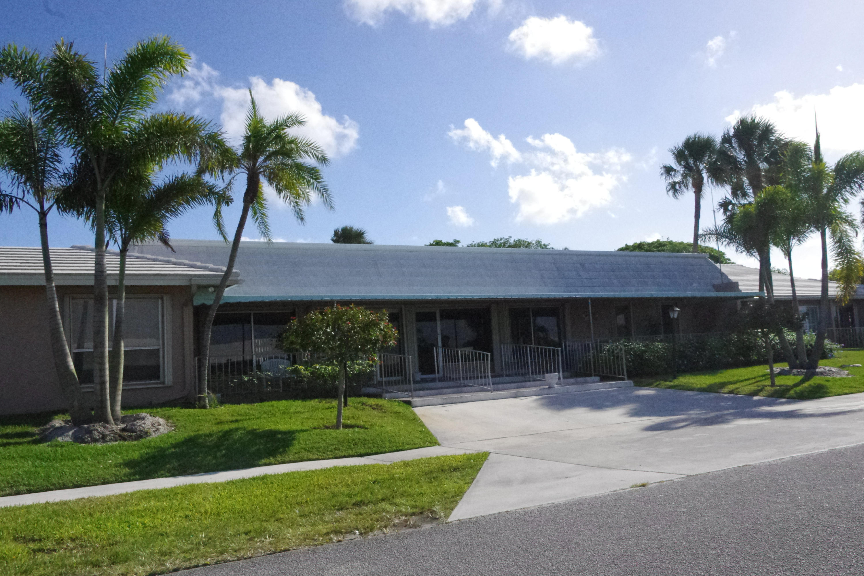 1310 Southwest 22nd Street Boynton Beach, FL 33426 - Photo 16 of 16 a view of a house with a yard and palm trees