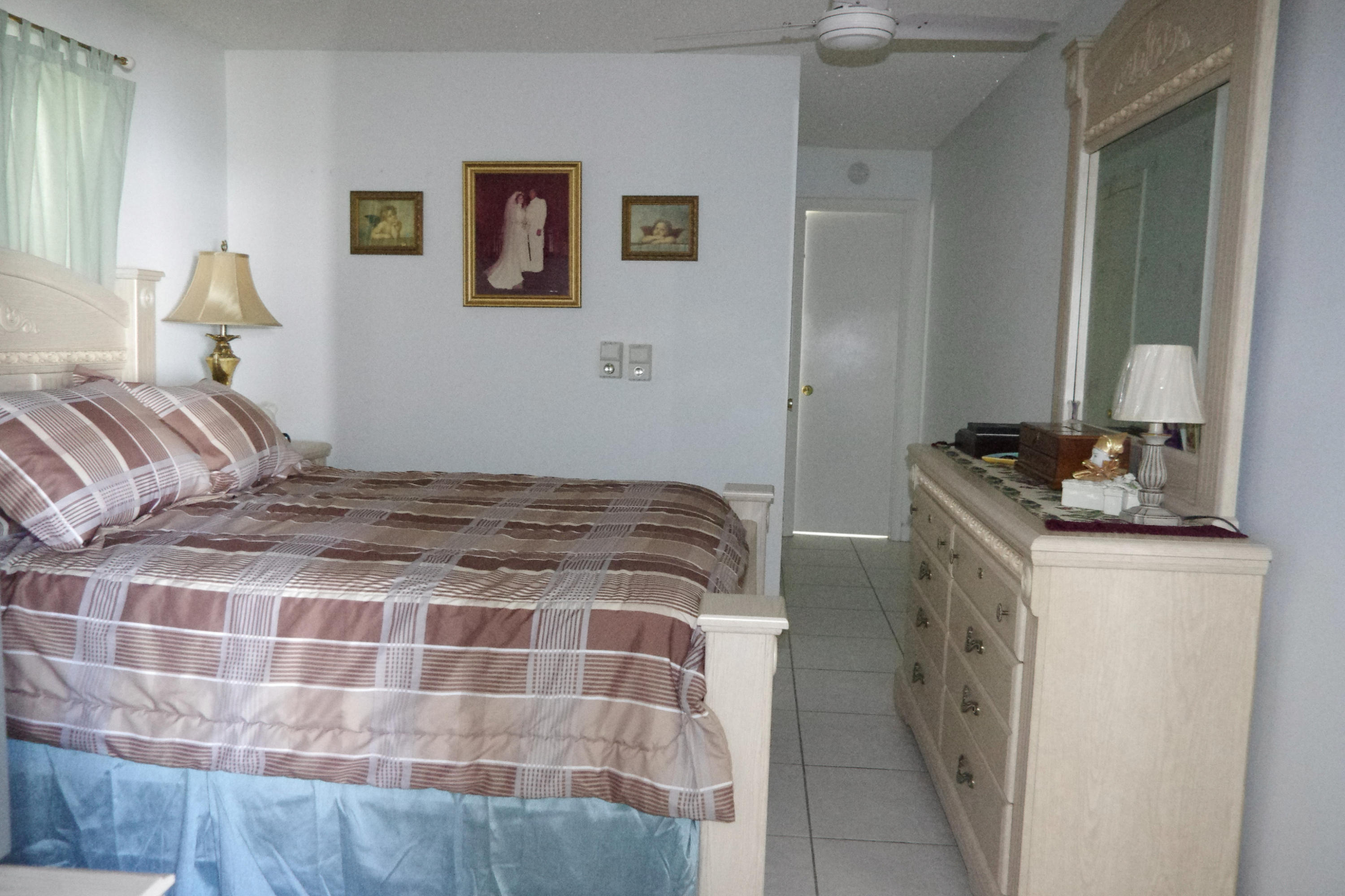 1310 Southwest 22nd Street Boynton Beach, FL 33426 - Photo 6 of 16 a bedroom with a bed and a cabinets