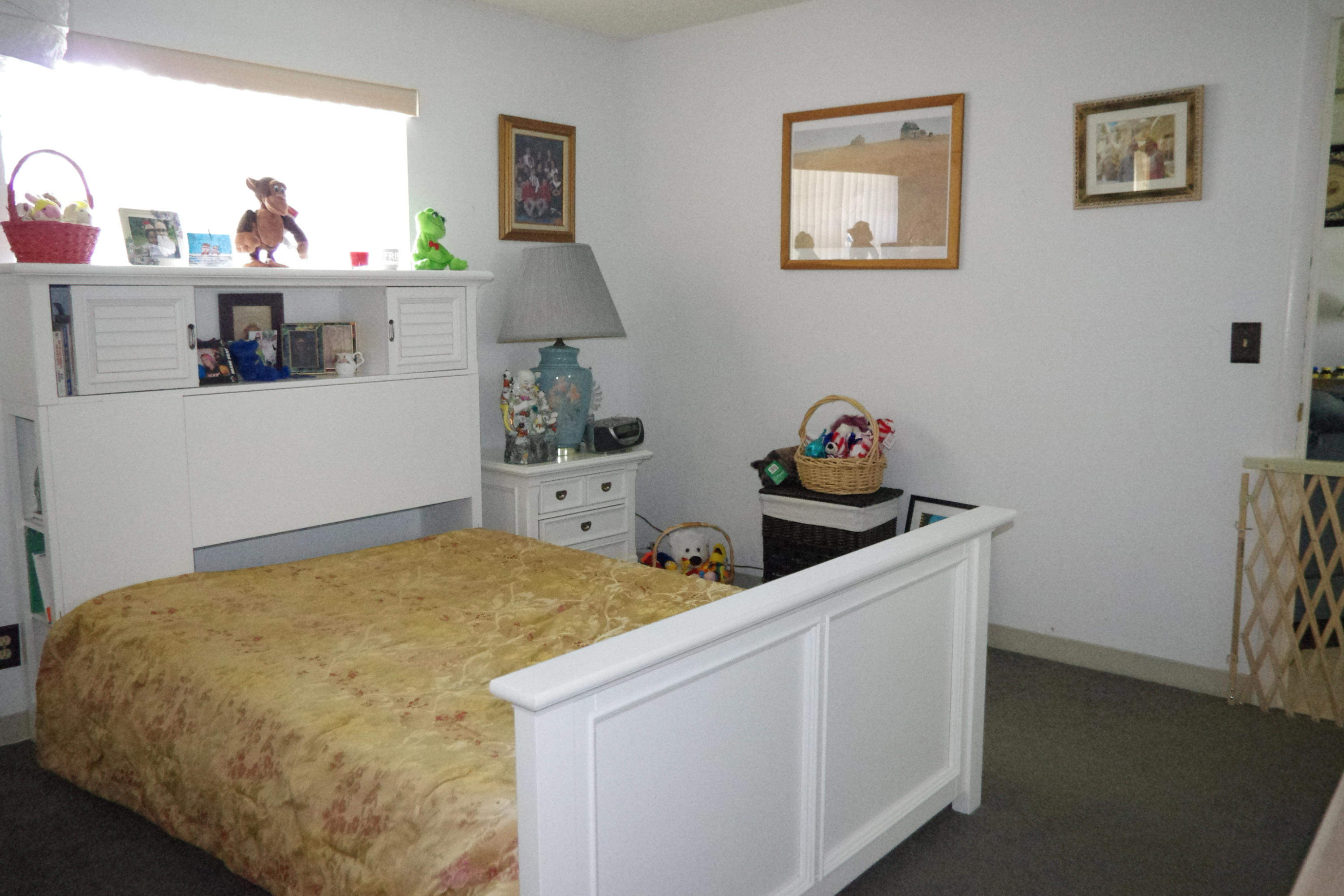 1310 Southwest 22nd Street Boynton Beach, FL 33426 - Photo 9 of 16 a bedroom with a bed and cabinets