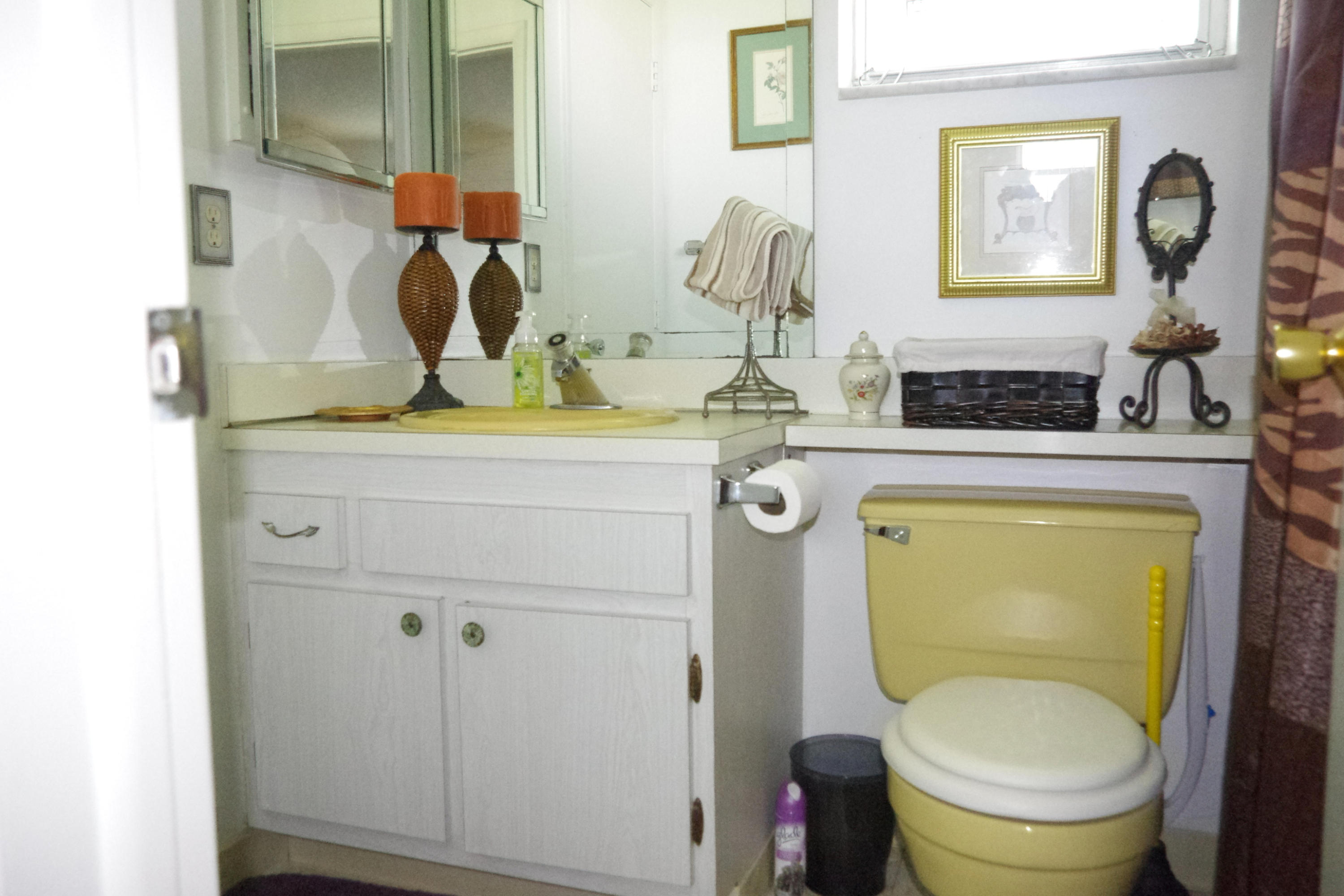 1310 Southwest 22nd Street Boynton Beach, FL 33426 - Photo 10 of 16 a bathroom with a toilet next to a sink