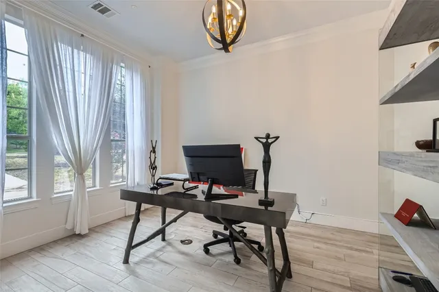 a view of a workspace with furniture and a window