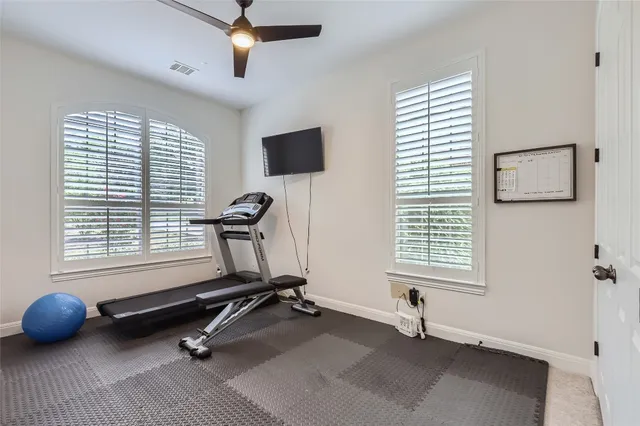a room with gym equipment and a window