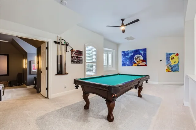 a living room with furniture projector and a screen