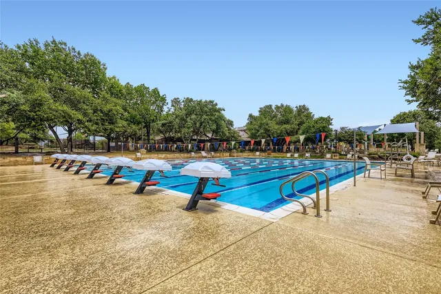 a house with a large trees in the background