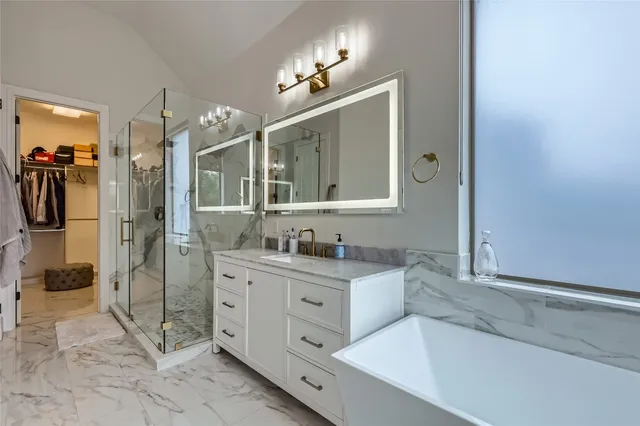 a spacious bathroom with a granite countertop sink mirror and shower