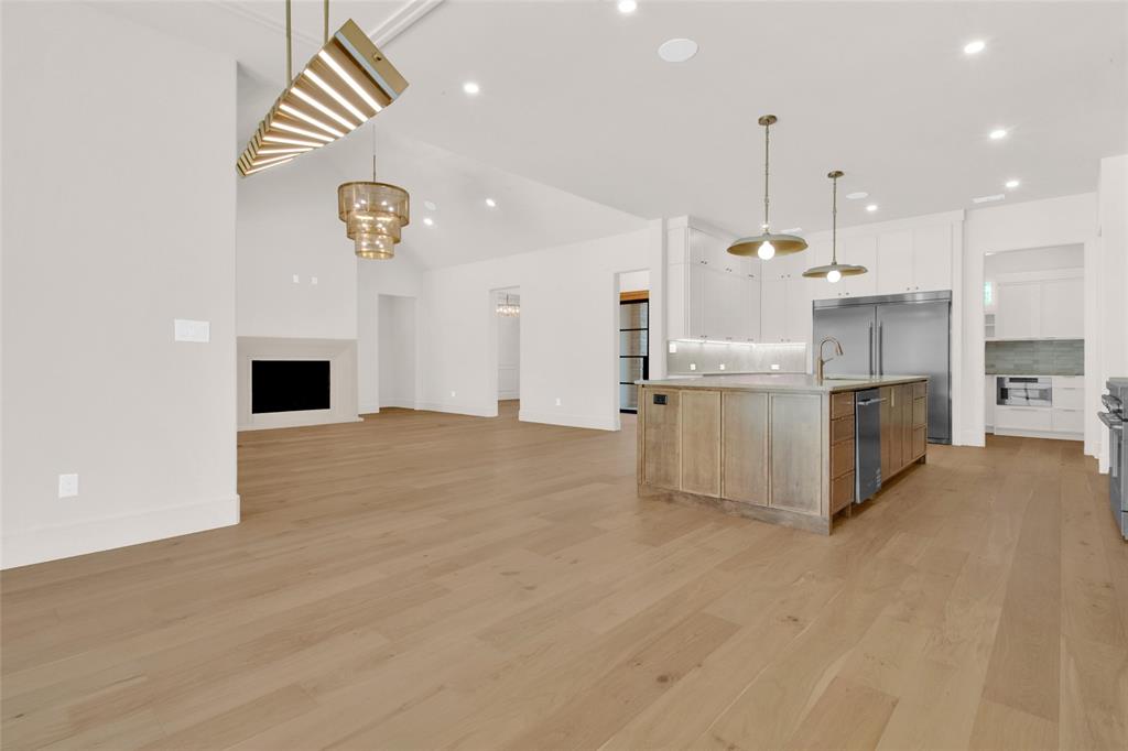 1839 Sentinel Way Tyler, TX 75703 - Photo 12 of 40 an open kitchen with kitchen island and stainless steel appliances