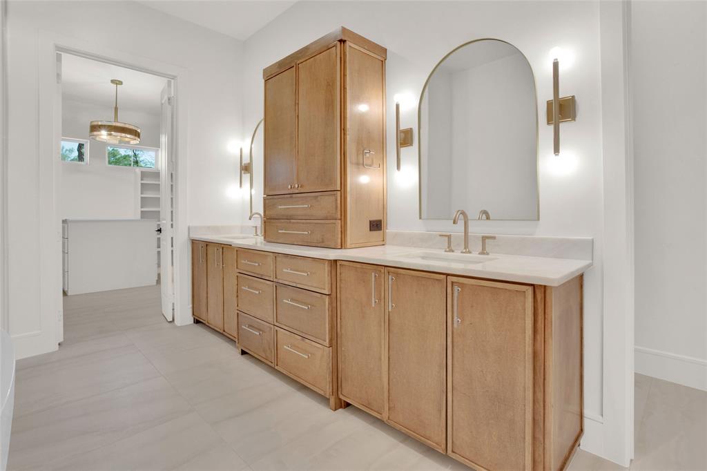 1839 Sentinel Way Tyler, TX 75703 - Photo 17 of 40 a spacious bathroom with a double vanity sink and a mirror