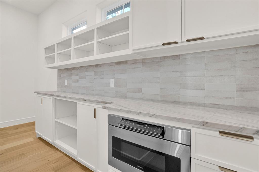 1839 Sentinel Way Tyler, TX 75703 - Photo 26 of 40 a view of white cabinets and a wooden floor
