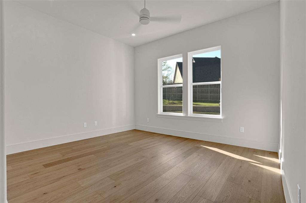 1839 Sentinel Way Tyler, TX 75703 - Photo 30 of 40 an empty room with wooden floor and windows