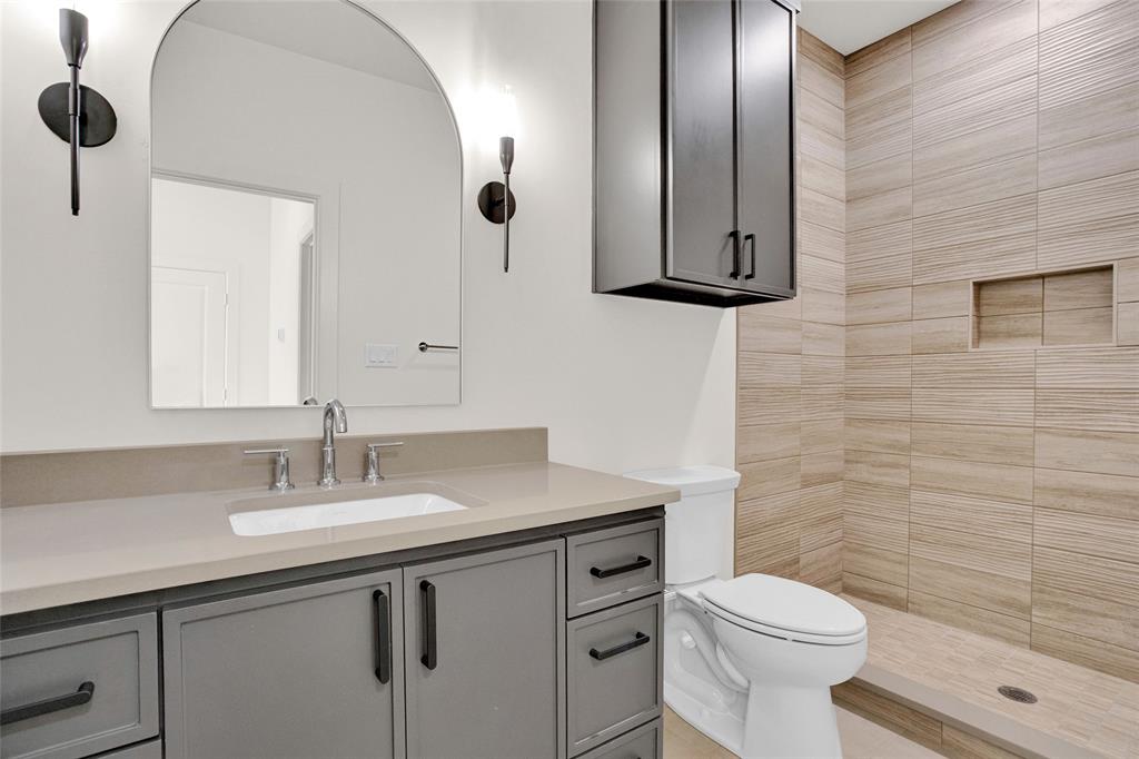 1839 Sentinel Way Tyler, TX 75703 - Photo 33 of 40 a bathroom with a toilet a sink a mirror and vanity