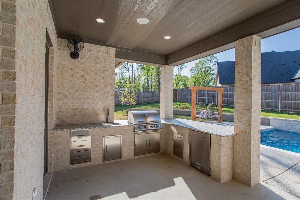 1839 Sentinel Way Tyler, TX 75703 - Photo 38 of 40 a kitchen with stainless steel appliances granite countertop a sink and a refrigerator
