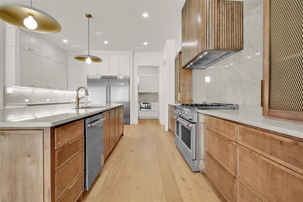 1839 Sentinel Way Tyler, TX 75703 - Photo 8 of 40 a kitchen with stainless steel appliances granite countertop a sink a stove and a refrigerator