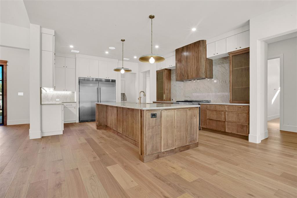 1839 Sentinel Way Tyler, TX 75703 - Photo 9 of 40 a large kitchen with stainless steel appliances a large counter top a refrigerator a sink and a oven