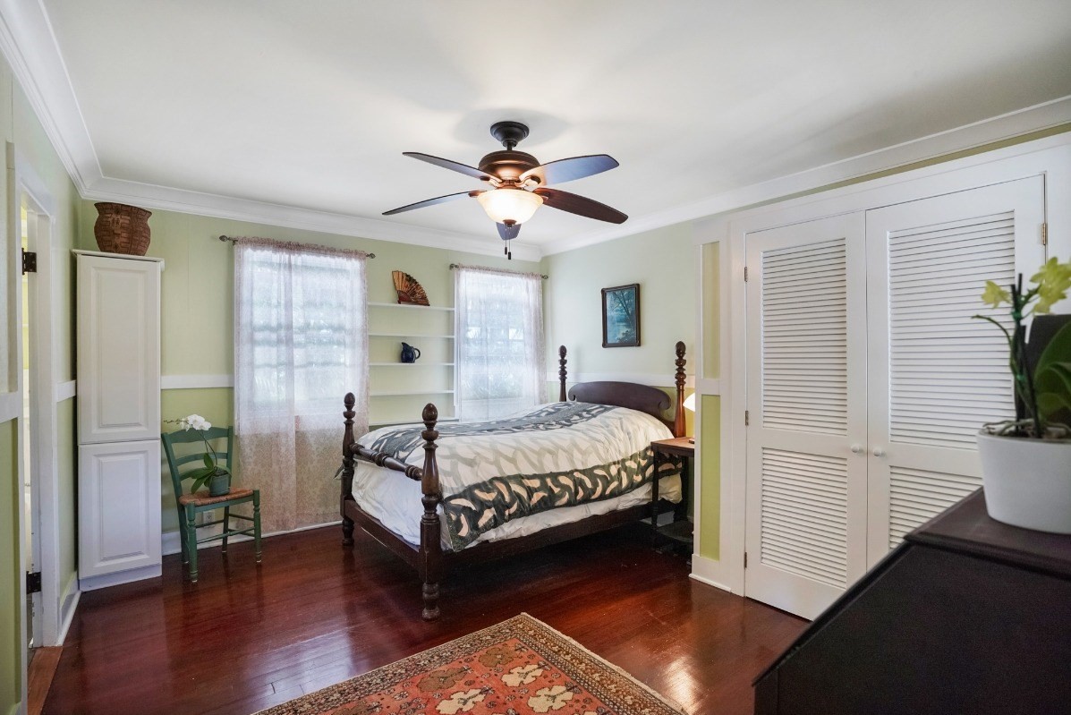 4378 Hookui Road Kilauea, HI 96754 - Photo 11 of 29 a bedroom with a bed and a chandelier