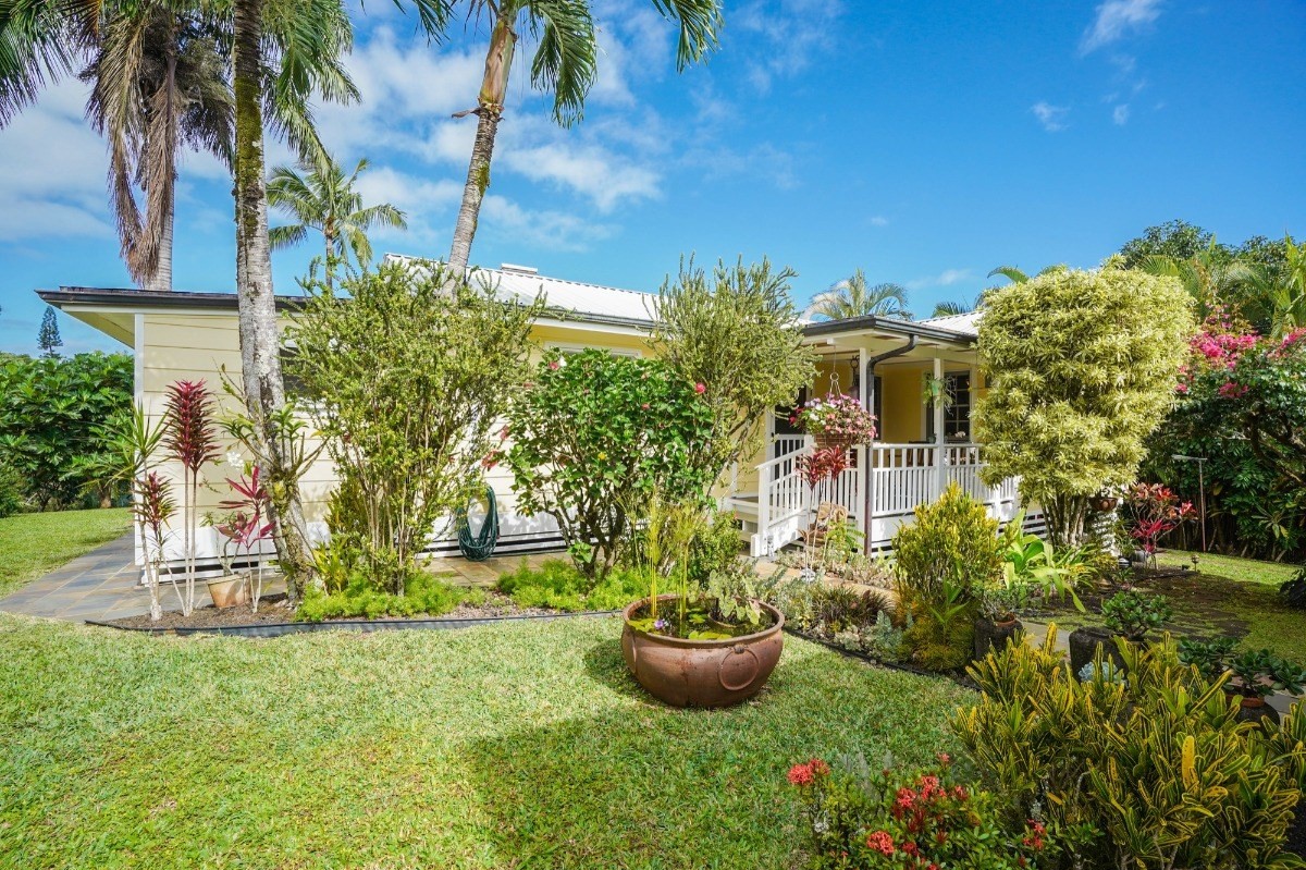 4378 Hookui Road Kilauea, HI 96754 - Photo 16 of 29 a view of a backyard with plants and fountain