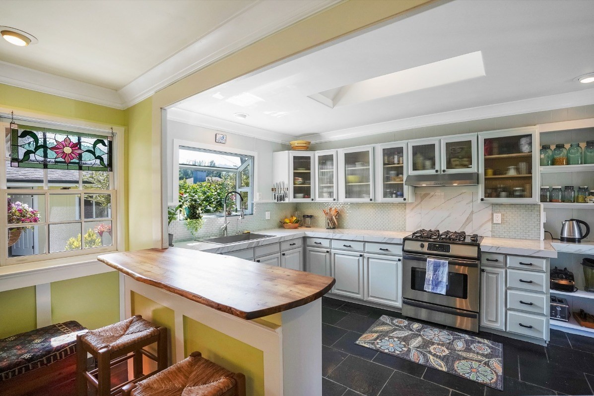 4378 Hookui Road Kilauea, HI 96754 - Photo 4 of 29 a kitchen with a stove and a refrigerator