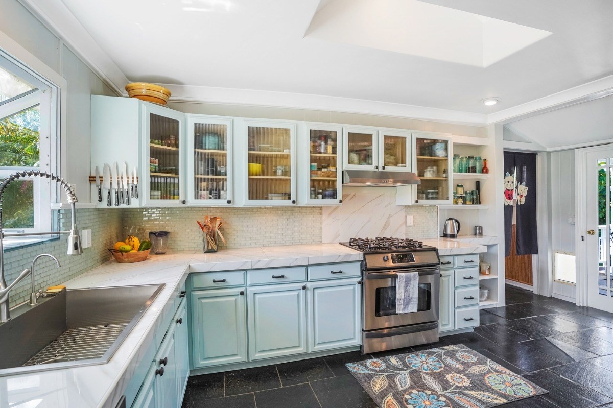 4378 Hookui Road Kilauea, HI 96754 - Photo 5 of 29 a kitchen with stainless steel appliances granite countertop a stove and a sink