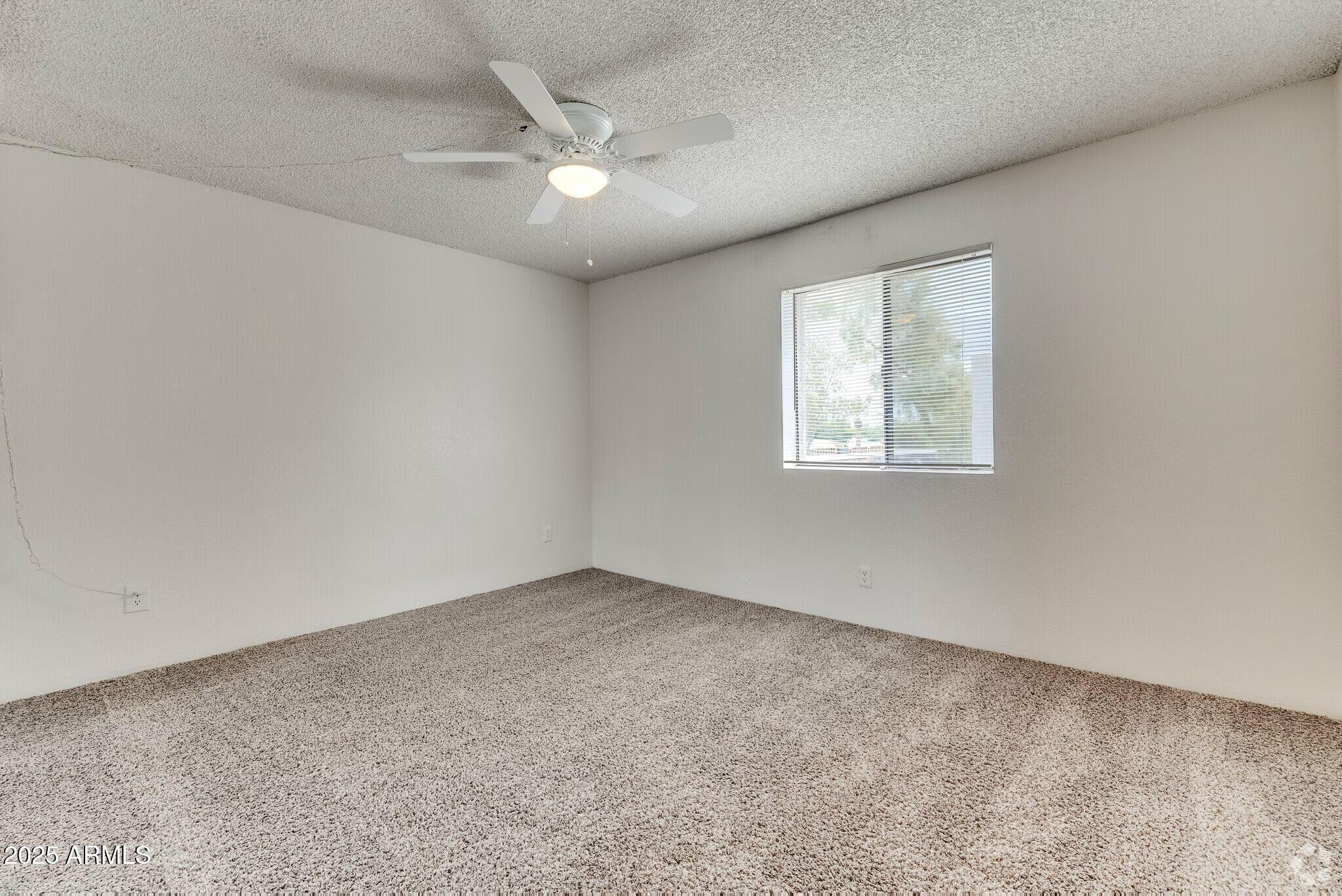 6505 East Osborn Road, Unit 22 Scottsdale, AZ 85251 - Photo 5 of 9 an empty room with a window