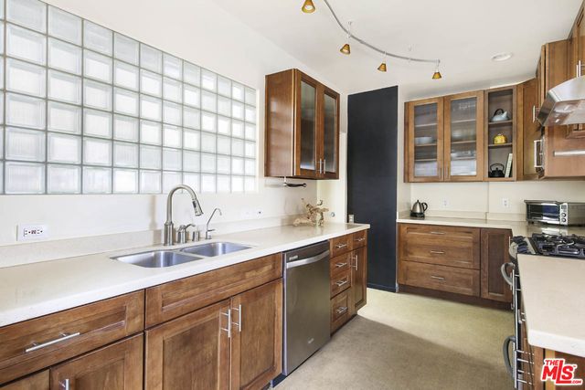 a kitchen with a sink stove and cabinets