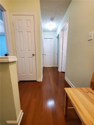 a view of a room with wooden floor and cabinet