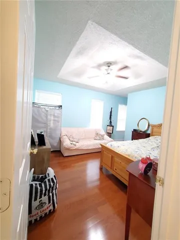 a bedroom with furniture and a chair