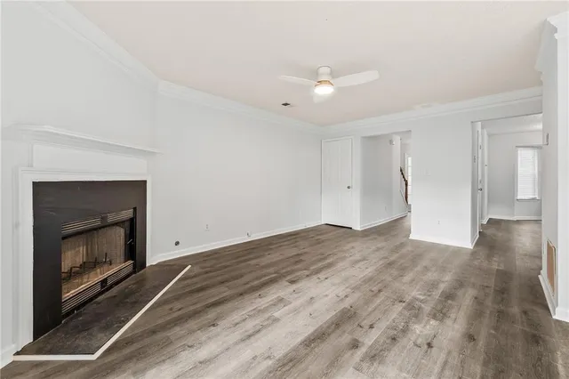 a view of empty room with wooden floor and fireplace