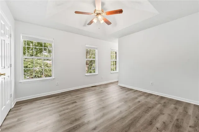 wooden floor in an empty room with a window