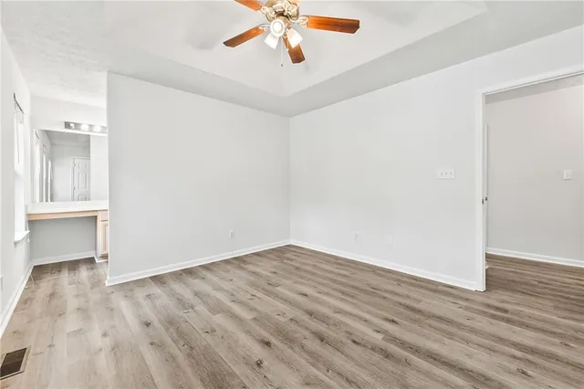 wooden floor in an empty room with a window
