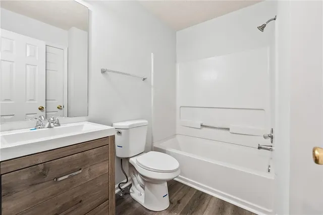 a bathroom with a sink a toilet and a bathtub