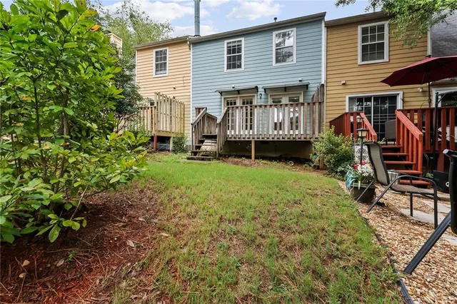 a view of an house with backyard and sitting area