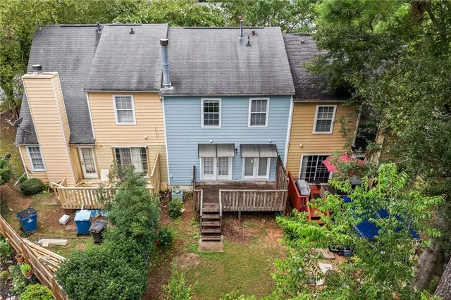 a aerial view of a house with table and chairs and a large tree