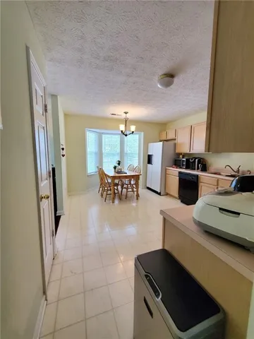 a kitchen with a table and chairs