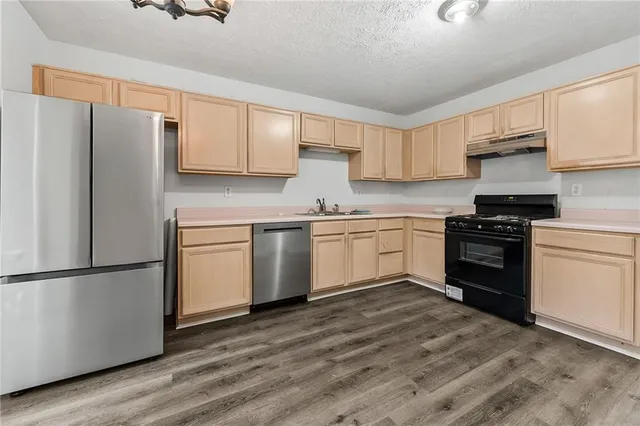 a kitchen with a white cabinets and white appliances