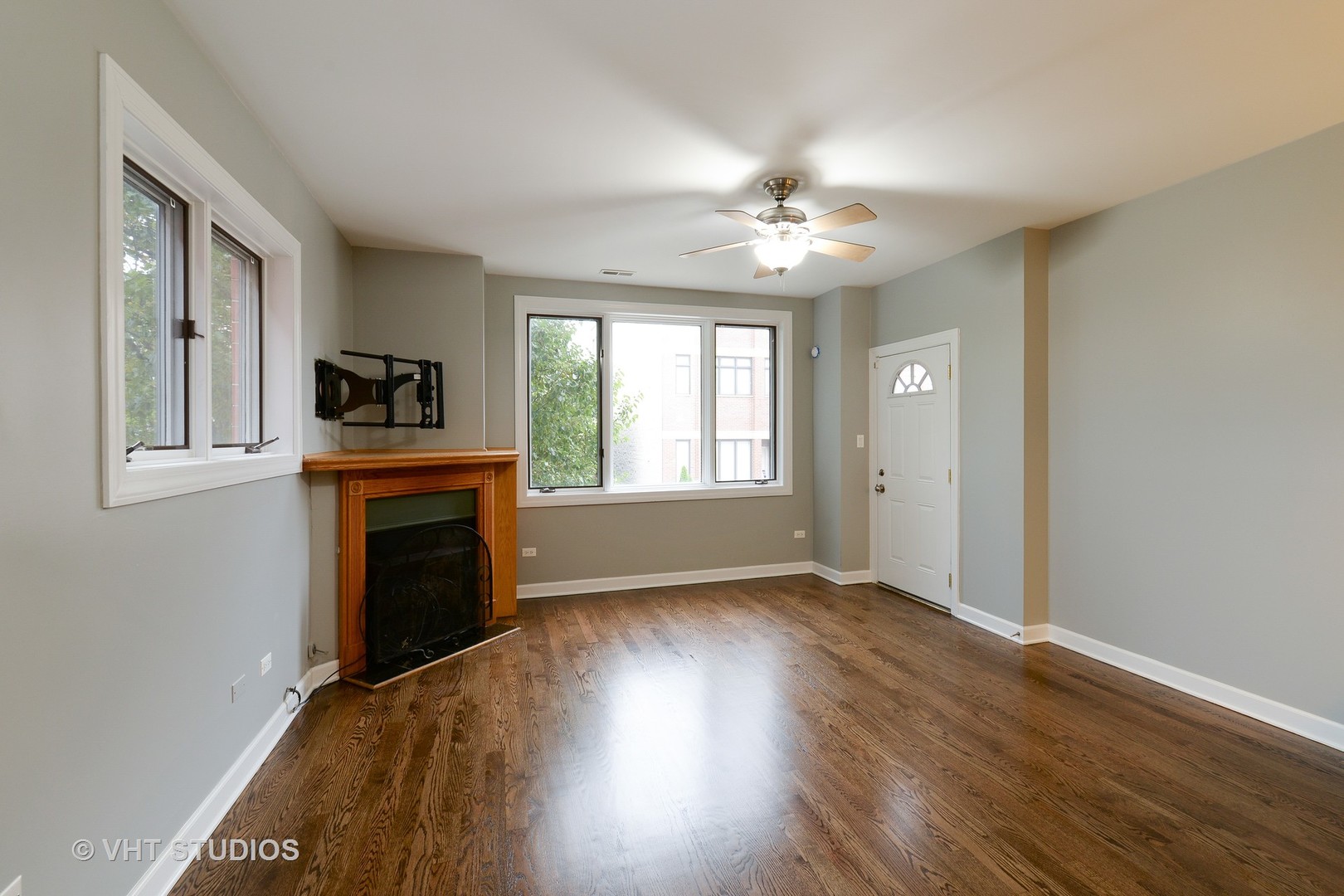 514 South Denvir Avenue, Unit 2 Chicago, IL 60612 - Photo 2 of 13 a view of an empty room with a fireplace and a window