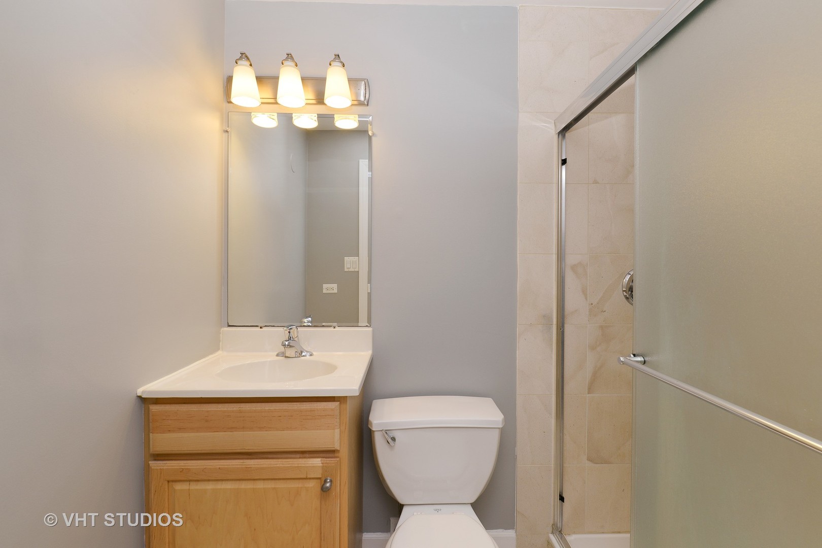 514 South Denvir Avenue, Unit 2 Chicago, IL 60612 - Photo 11 of 13 a bathroom with a toilet sink and mirror