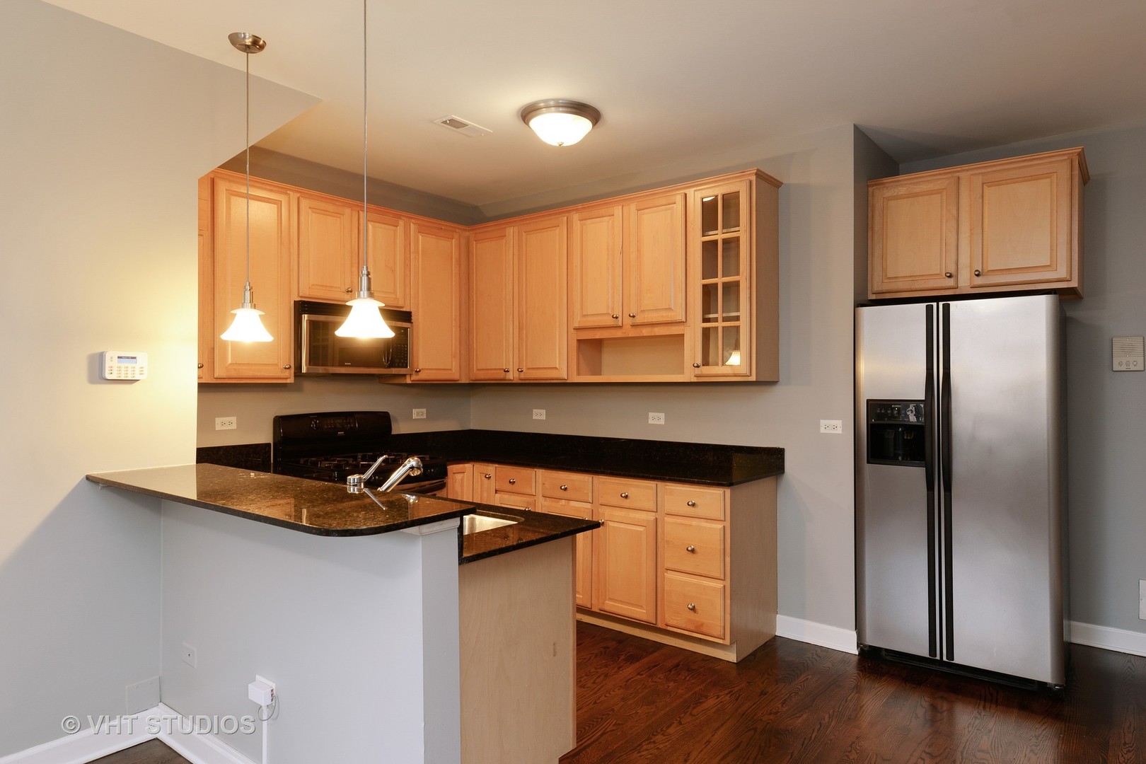 514 South Denvir Avenue, Unit 2 Chicago, IL 60612 - Photo 3 of 13 a kitchen with kitchen island a counter space a sink a refrigerator and cabinets