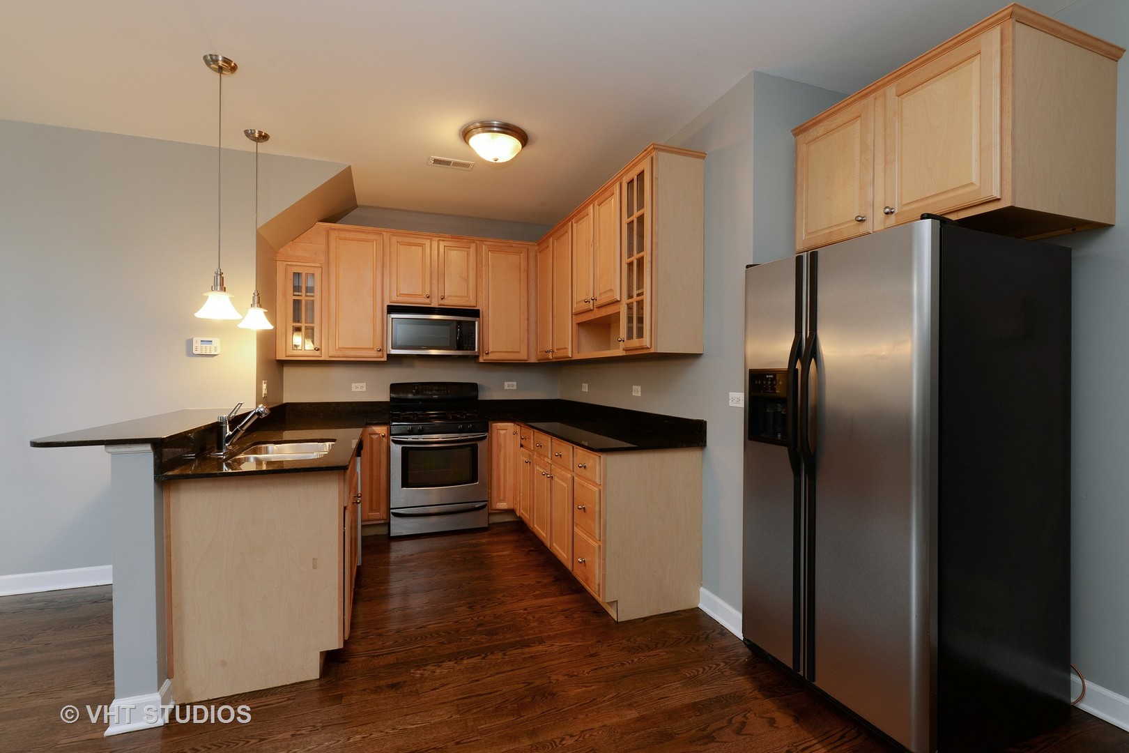 514 South Denvir Avenue, Unit 2 Chicago, IL 60612 - Photo 4 of 13 a kitchen with stainless steel appliances granite countertop a refrigerator a stove top oven a sink and dishwasher