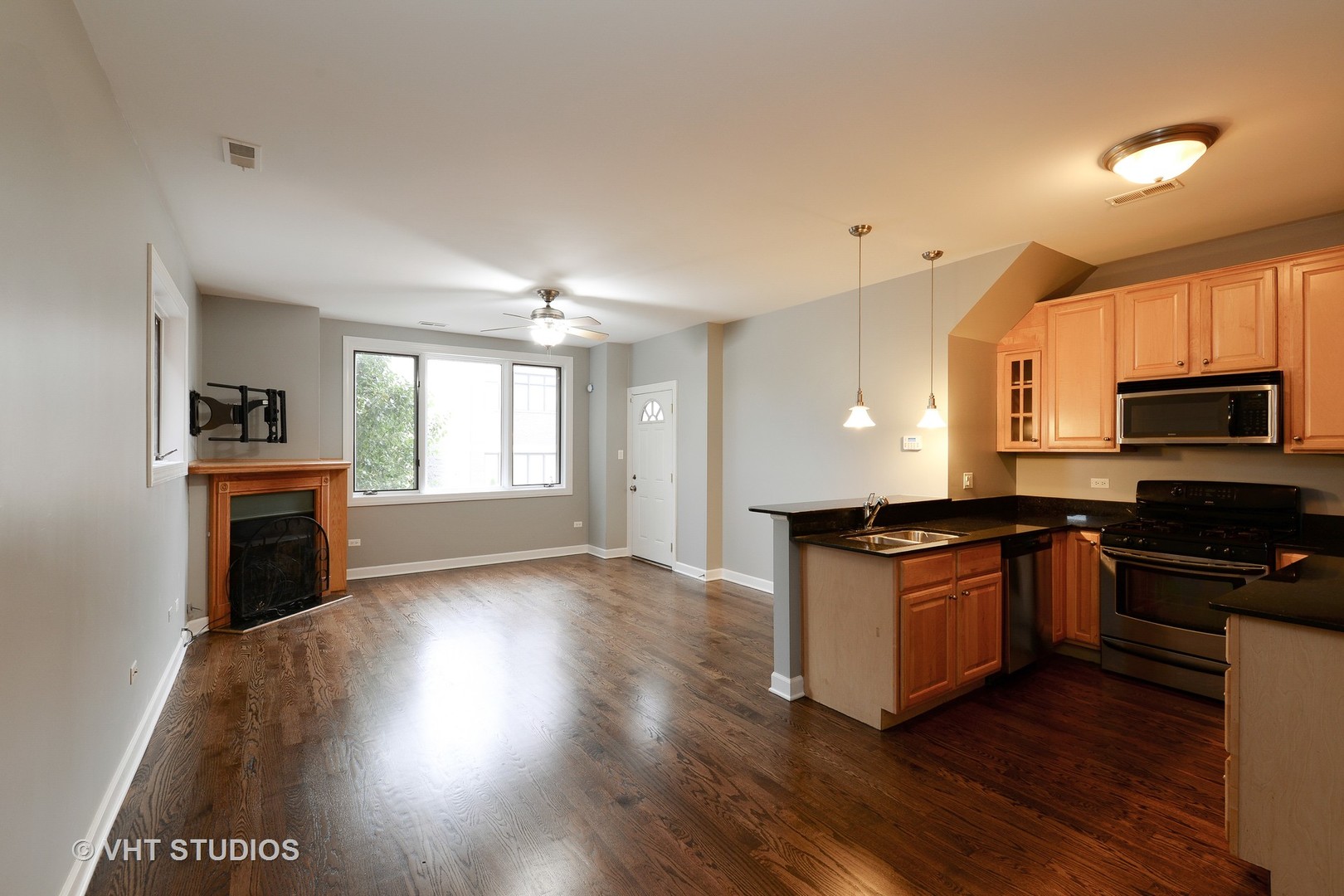 514 South Denvir Avenue, Unit 2 Chicago, IL 60612 - Photo 5 of 13 a kitchen with granite countertop a stove top oven and sink